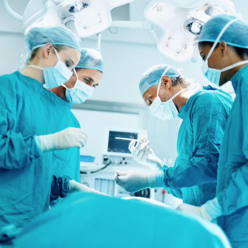four surgeons in an operating room