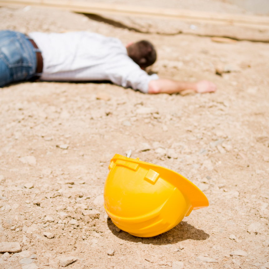 worker has fallen and construction hat is on the ground nearby